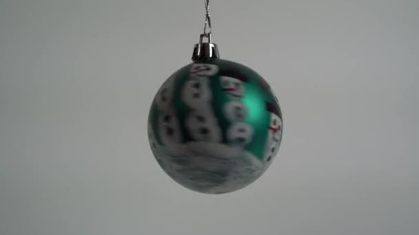 Hand Spins Christmas Ball Painted Himself Snowmen — Stock Video