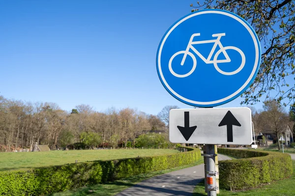 Blue bicycle sign on a cycle path