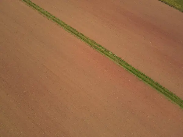 Aerial view of farm fields with soil in the countryside