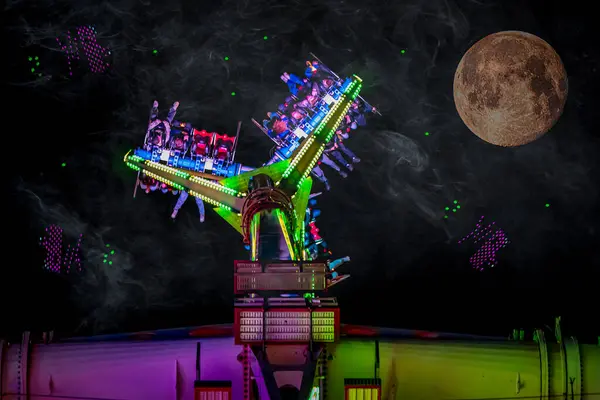 Moonlit Night Colorful Spinning Amusement Ride Stock Image