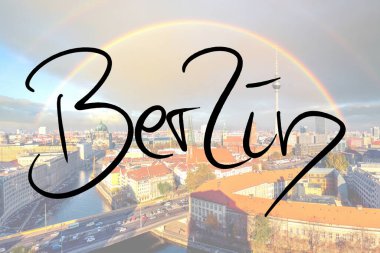 Berlin handwritten with a photo of the city in the background 