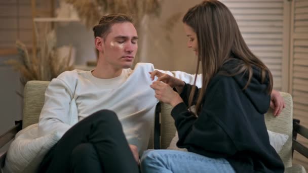 Young Woman Gently Applies Eye Patches Her Boyfriend Face — Videoclip de stoc