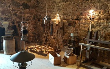 Collection of very old wooden carpentry tools in stone shed.