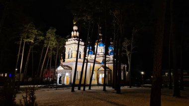 An Orthodox church is illuminated by floodlights at night in the Latvian city of Jurmala in January 2023.