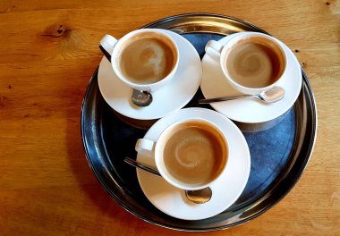 Aromatic delicious coffee in cup standing on tray is prepared for breakfast.