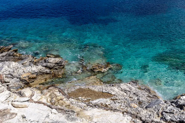 Stock image Background. Water. The texture of the iridescent surface of the sea and cliffs