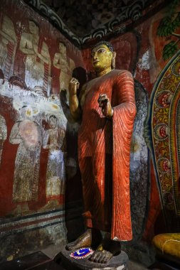 Buddha statue and fresco in the Buddhist cave temple in Dambulla, Sri Lanka clipart