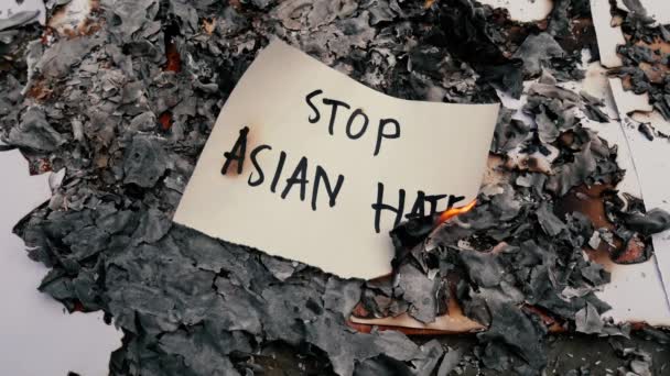 Burning Paper English Words Stop Asian Hate Background Ashes Racism — стоковое видео