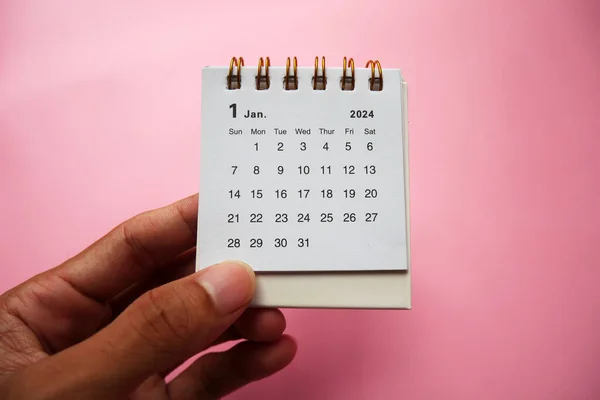 Welcome 2024. January 2024 desk calendar isolated on pink background. Similar image on my portfolio.