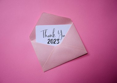 A piece of paper in an envelope with the words BYE BYE 2023. Goodbye 2023, welcome 2024. clipart