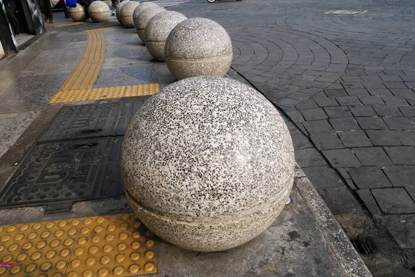 round stones on street sidewalks as urban planning architectural art and pedestrian seating