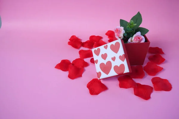 Valentine\'s day gift box. Happy valentines day banner design with present box and roses on pink background. Copy space.