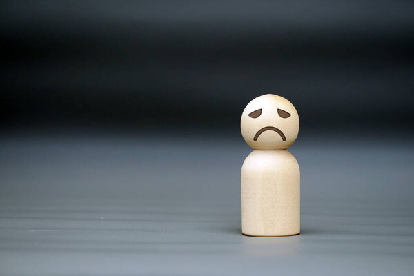 Lonely Wooden Figure with Sad Face, Representing Depression, Anxiety, Loneliness, and Mental Health Struggles in Society