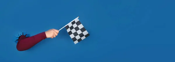 Hand Holding Checkered Flag Blue Background Panoramic Layout — Stock Photo, Image