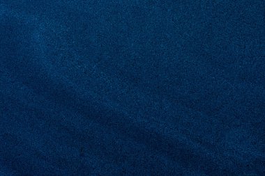 İnce eğimli ince taneli koyu mavi kum dokusu, arka plan ve dizayn örtüleri için ideal..