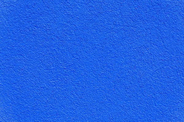 İnce desenli kaba mavi bir duvara yakın plan, arka plan, tasarım modellemeleri veya mimari kullanım için ideal.