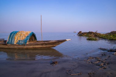Landscape View of wooden fishing boats on the bank of the Padma river in Bangladesh