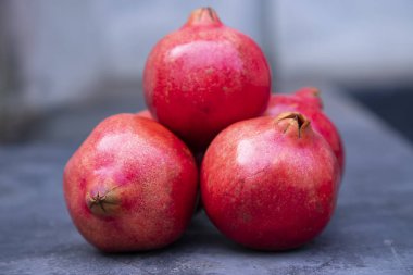 Ripe pomegranates on a dark background. Selective focus