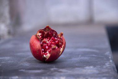 Ripe pomegranate fruit on a black background. Healthy food