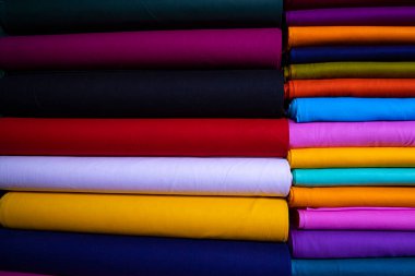 Artistic variety shade tone colors Textile Fabrics stacked on retail Shop Shelf to sale
