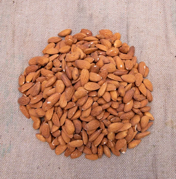 Some almonds on the brown Jute fiber fabric