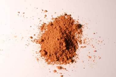 Beyaz arka planda dağılmış turuncu masala taneleri, ilginç bir kontrastlık yaratır.