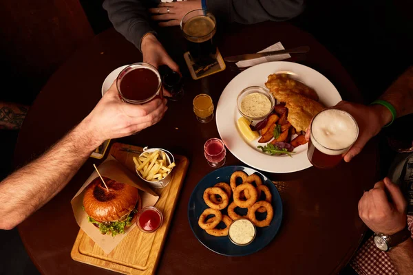 stock image Man and woman drink lager beer and stout. Friends having alcoholic drinks in the bar