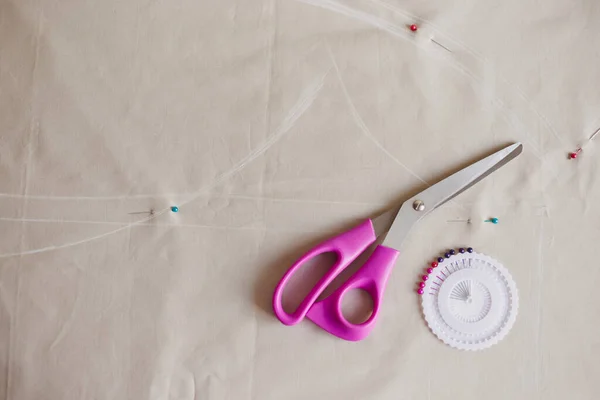 stock image Sewing accessories on fabric pastel color. Process of creating clothes. Workplace of seamstress