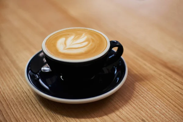 stock image Cup of coffee on the table in cafe. Cappuccino or latte in mug. Enjoying time alone