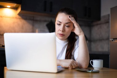 Close up unhappy stressed businesswoman reading bad news in email, frustrated student working on difficult task, online project. Hard remote work. Work on the kitchen office