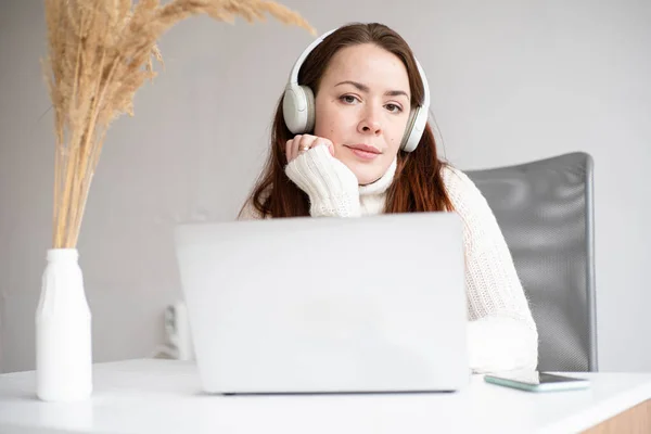 Caucasian Female Enjoying Music Podcast Holding Smartphone Red Hair Woman Imagen de stock