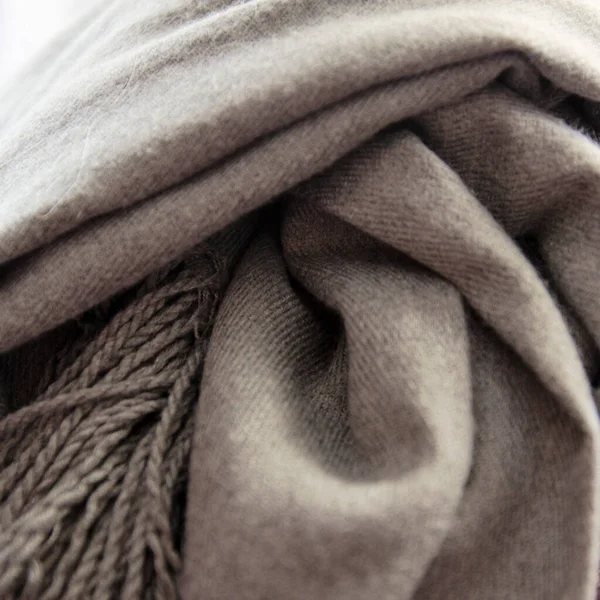 stock image Knotted soft warm gray scarf. Winter textiles. Close-up. High quality photo