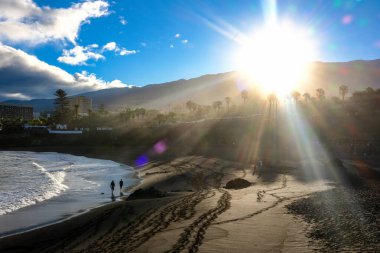 Puerto de la Cruz, Tenerife, Spain - October 28, 2023: People by the ocean in the evening. Local life clipart