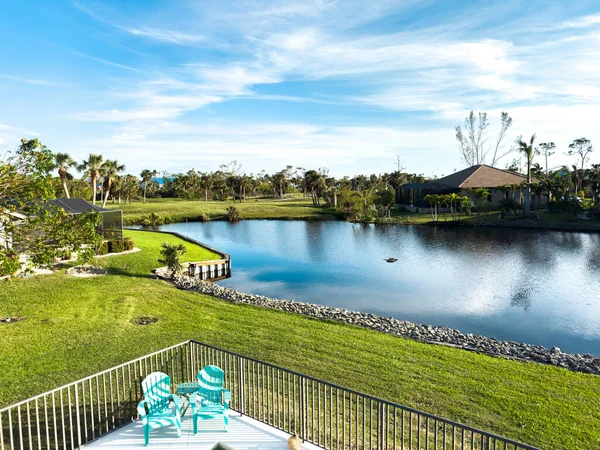 stock image Florida home with back yard pool with blue skies. Rental property Florida. Lake surrounding