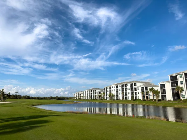 Retirement community condos on a resort golf course southwest Florida. Blue skies with water and lush green turf