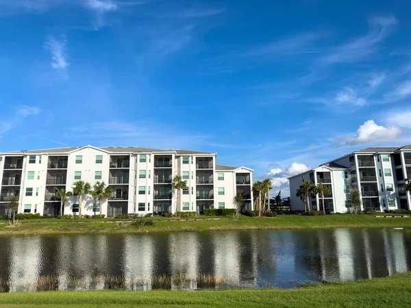 Retirement community condos on a resort golf course southwest Florida. Blue skies with water and lush green turf