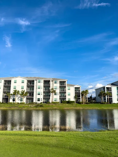 Retirement community condos on a resort golf course southwest Florida. Blue skies with water and lush green turf