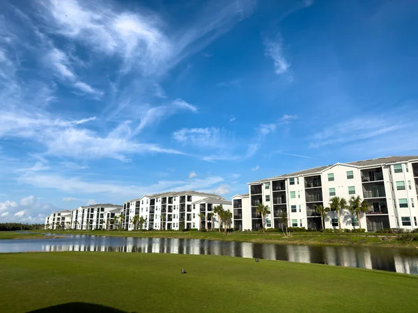 stock image Retirement community condos on a resort golf course southwest Florida. Blue skies with water and lush green turf