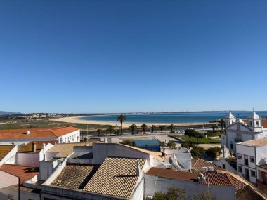 Old town in the center of Lagos, Algarve region, Portugal. Showing beach with blue skies