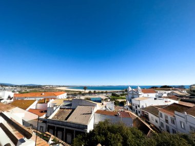 Old town in the center of Lagos, Algarve region, Portugal. Showing beach with blue skies