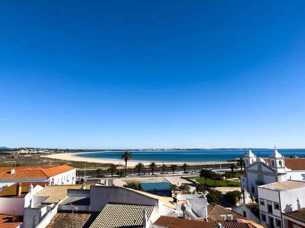 Old town in the center of Lagos, Algarve region, Portugal. Showing beach with blue skies