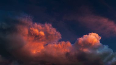 Crimson dramatic sky before rain, panorama. The clouds are lit up at sunset, an unsettling apocalyptic mood.