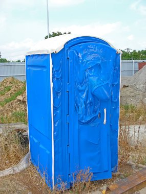 Cabin of a blue bio-toilet that melted from a fire. Melted plastic.