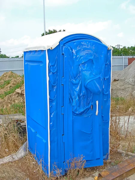 Cabin of a blue bio-toilet that melted from a fire. Melted plastic.