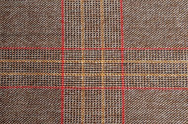 Dokulu kumaşın yakın görüntüsü. Klasik ekose tasarımlı birbirine geçmiş karmaşık iplikçikler içerir..