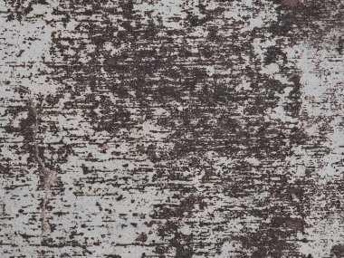 Eski bir beton duvarın yüzeyinde çatlak izleri var.