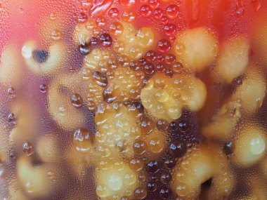 Uzun saçlı siyah kadın kolye takıyor.