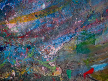 Masaya sürülmüş boyanın renkli desenleri var.