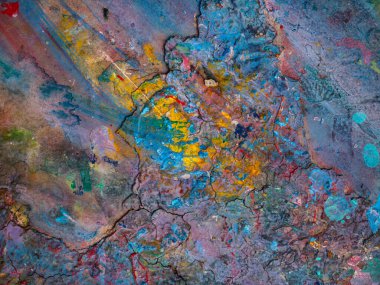 Masaya sürülmüş boyanın renkli desenleri var.