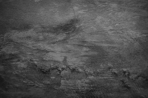 Texture of black polished concrete background. Dark old wallpaper with rough cement texture. Empty grunge wall concept or floor backdrop. Abstract surface mockup. Top view, close up, copy space